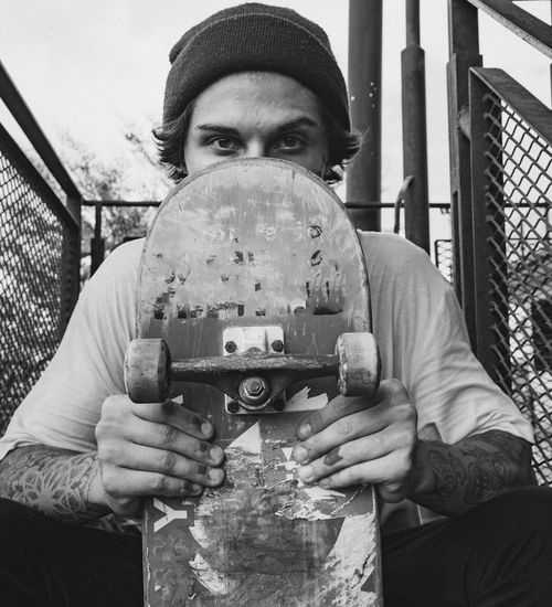 Man holding a kettlebell with a determined expression.